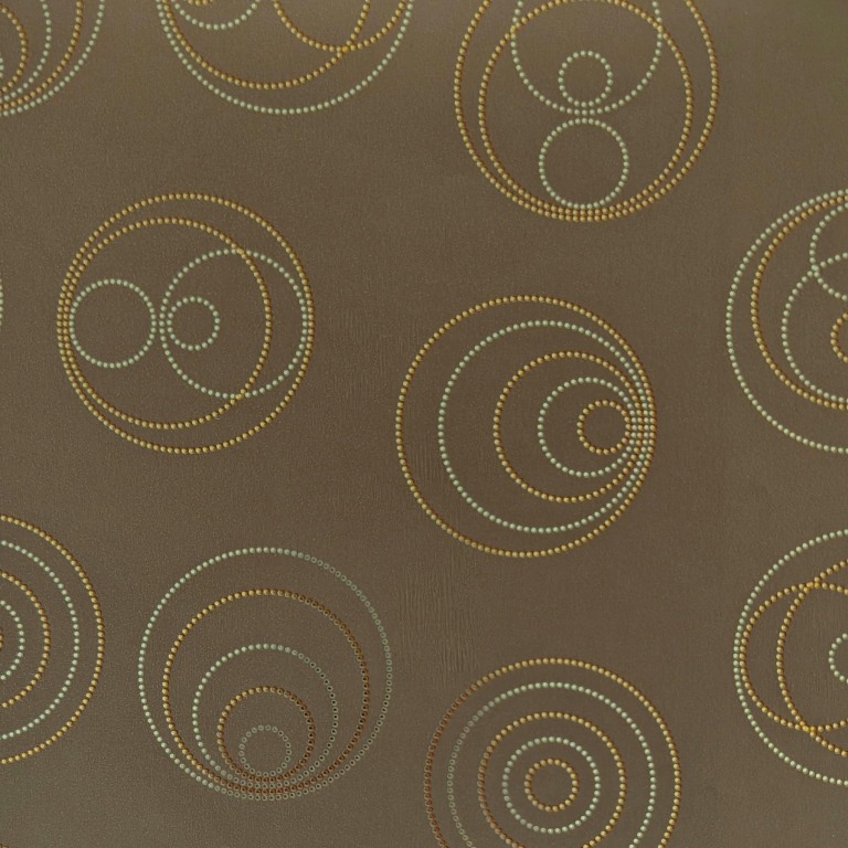 Gift wrapping paper mirror with shiny dots in a circle shape on a matte taupe background.
 