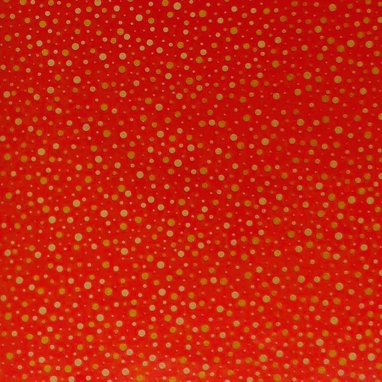 Gift wrapping paper mirror shiny gold dots on a deep matte red background.
 