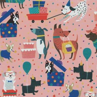 Counter rolls of wrapping paper dog birthday party with pink background on strong white paper.
 