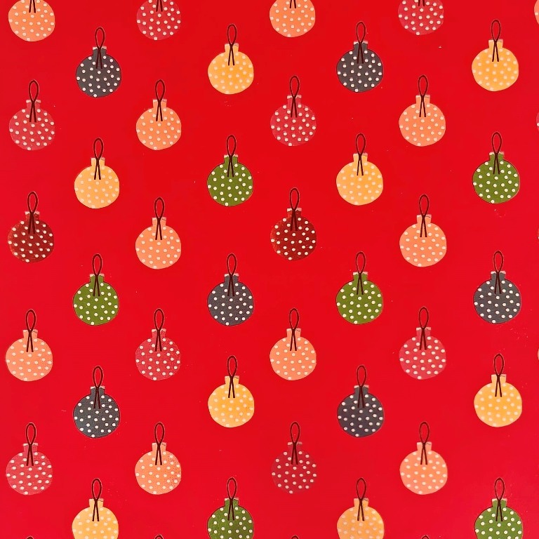 Gift wrapping paper with a matte red background and colorful metallic christmas baubles on metallized paper.
 